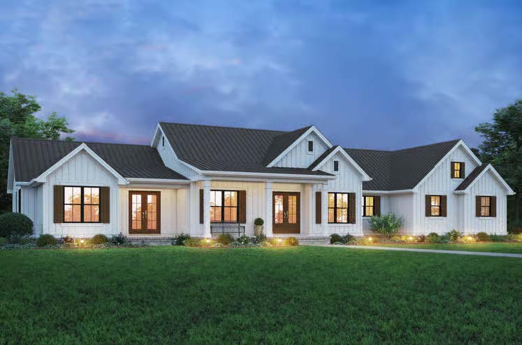 The Cedar Run — modern farmhouse exterior at dusk with board-and-batten siding, metal roof and covered wraparound porch