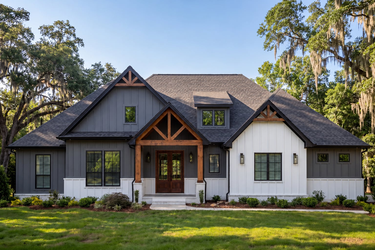 The Long Horn Estate — charcoal-gray and white board-and-batten modern farmhouse facade with a wood-accented gable entry porch, framed by mature oaks
